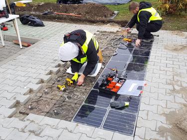 Workers repairing solar panels